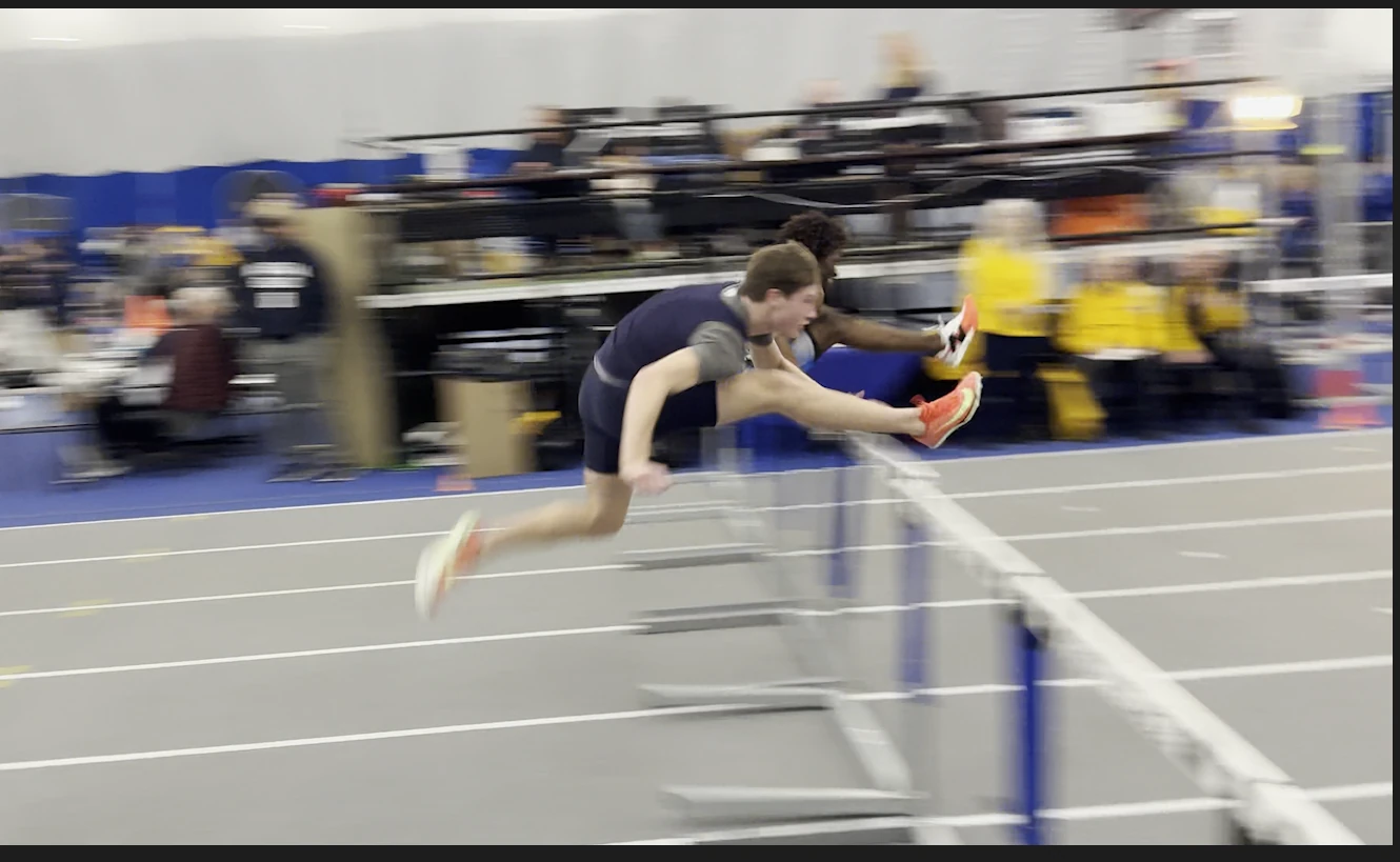 Seamus McGuire clearing an indoor hurdle